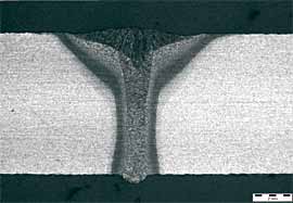 Fig. 1. Cross-section through a hybrid weld made over a flush, close fitting V butt joint. 2mm scale bar 