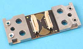 Fig. 1. CrackFirst TM sensor with connectors for electronics and reinforcing pads 